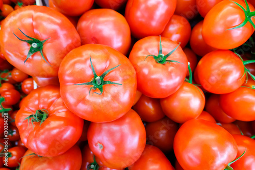 Fotografie Close up of fresh, juicy, ripe tomatoes pile