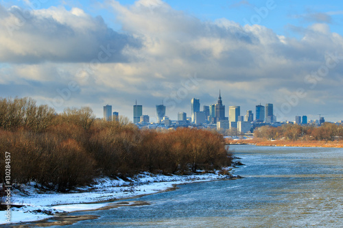 Warsaw sky line with skyscrapers of city center, Vistula river shore in winter