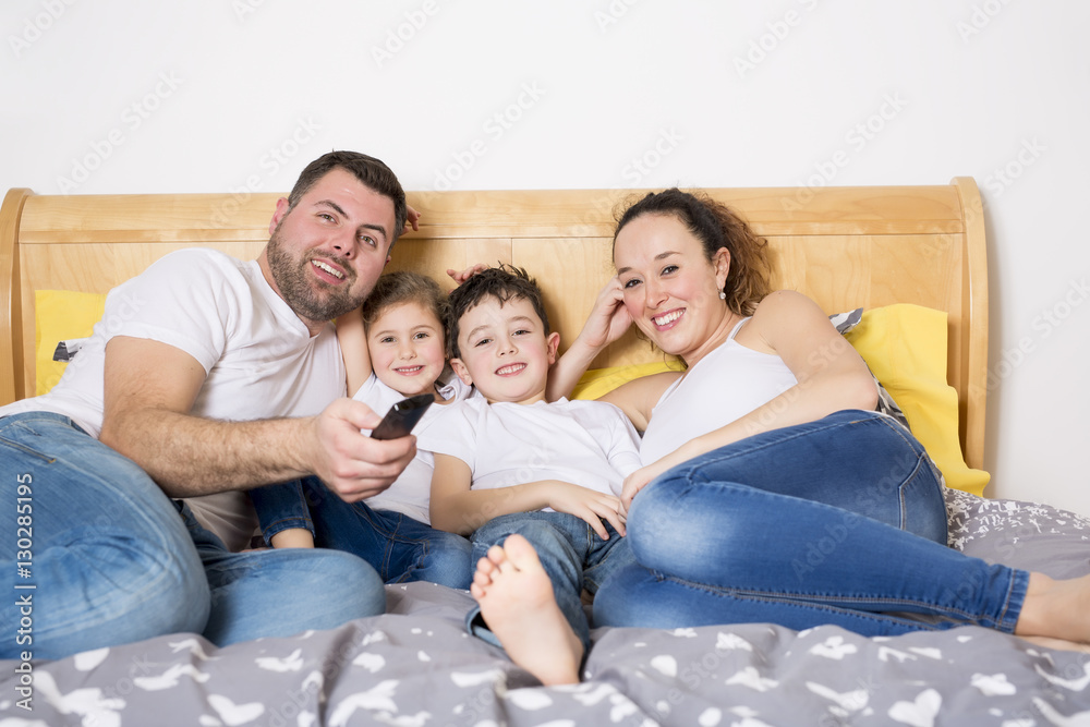 family, children and home concept - happy family with two kids under blanket at home family, children and home concept - happy family with two kids under blanket at home