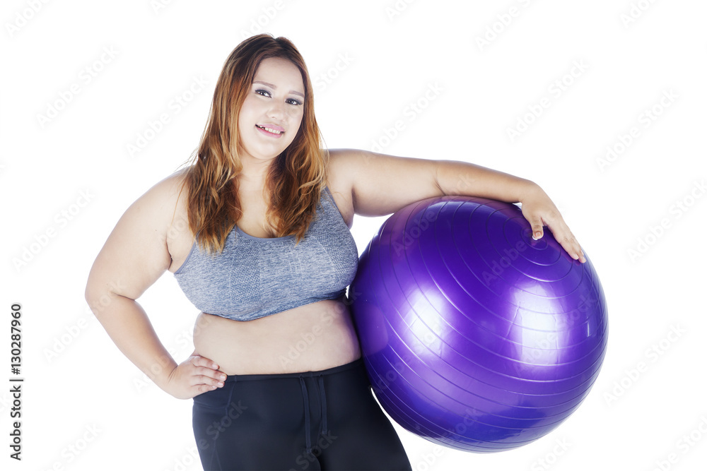 Overweight woman holding a purple ball Overweight woman holding a purple ball