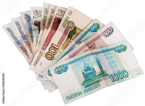 Russian banknotes lie on a table fan. Different nominal money is not new on the table isolated on white background.