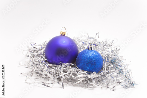 purple and blue balls with sparkles on silver tinsel isolated on white background
