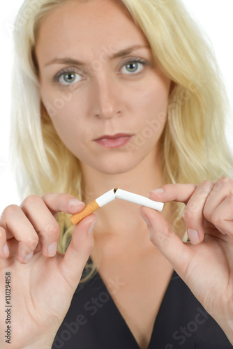 Lady breaking cigarette in half