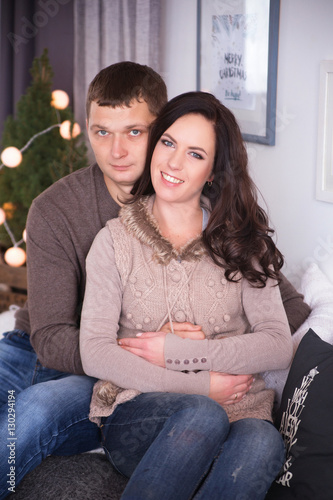 Beautiful young couple relaxing in a living room with new year t © ribalka yuli