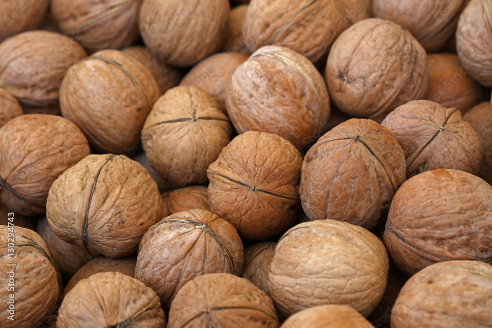 Whole walnuts in nutshells close up Whole walnuts in nutshells close up