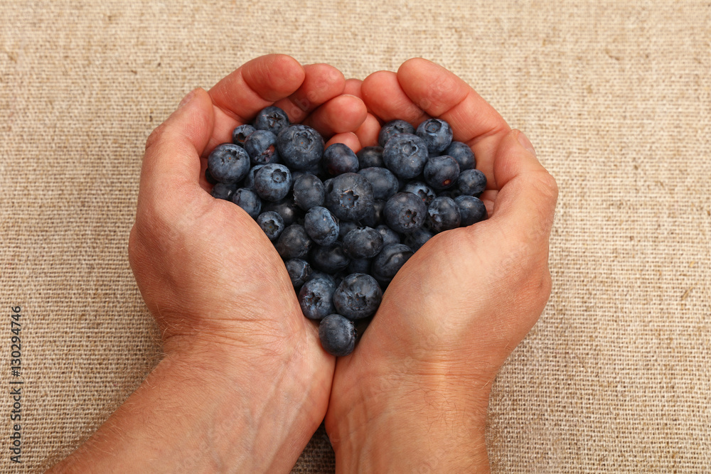 Man hands with heart shaped blueberries Man hands with heart shaped blueberries