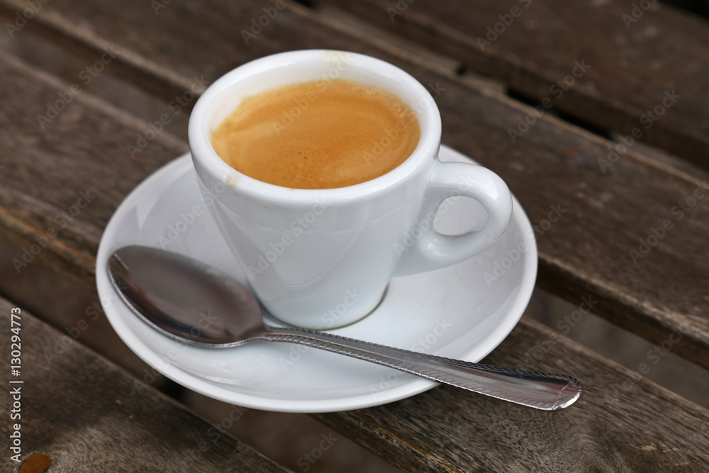 Espresso coffee in white cup close up on table Espresso coffee in white cup close up on table