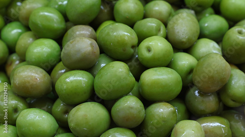 Green whole olives close up background