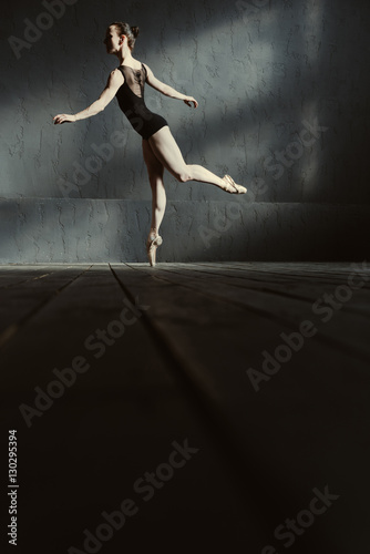 Graceful ballet dancer standing on the tiptoe in the studio