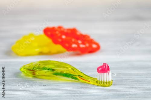 children s toothbrush oral care on wooden background