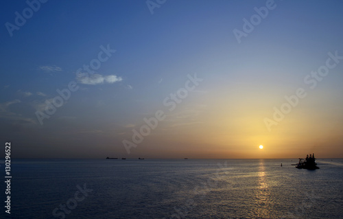calm ocean sunset with boats © Katrina