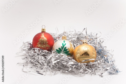 red white gold Christmas balls on silver tinsel in isolation on a white background