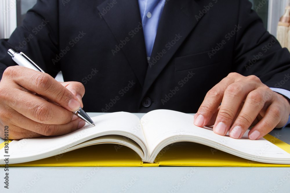 Business man writing diary Business man writing diary