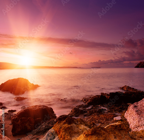 Beautiful colorful sunrise at the sea with dramatic clouds and sun shining. Beauty world natural outdoors travel background