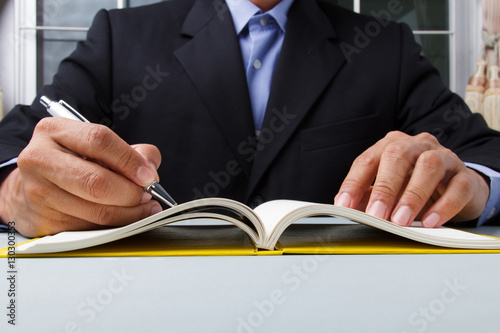 Business man writing diary