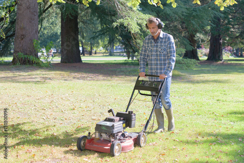 Man pushing mower