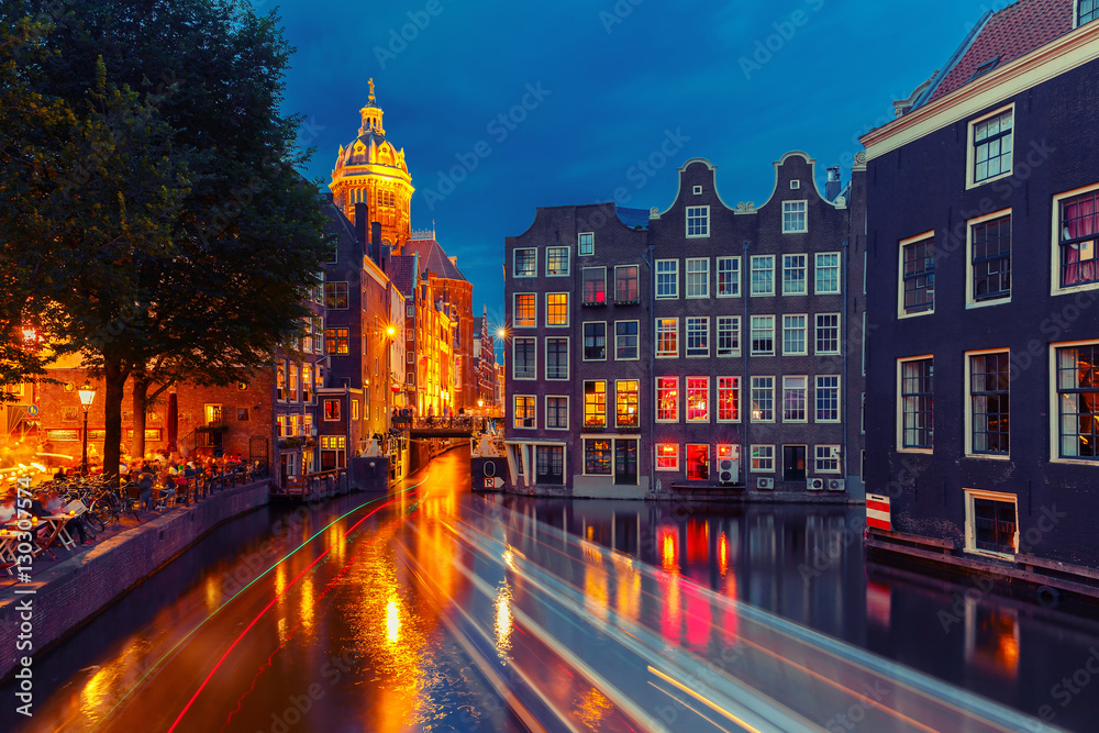 Night city view of Amsterdam canal, bridge and typical houses, Holland, Netherlands. Long exposure. Used toning