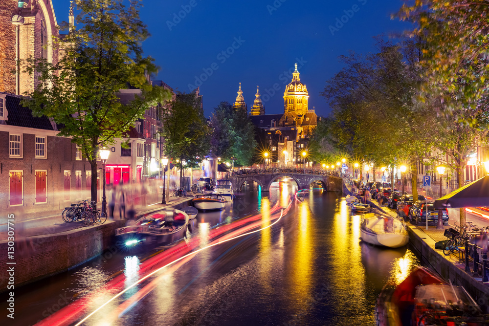 Night red-light district De Wallen, canal, Basilica of Saint Nicholas and bridge, Amsterdam, Holland, Netherlands. Long exposure. Used toning