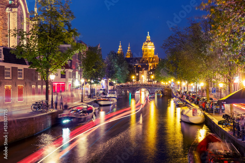 Night red-light district De Wallen, canal, Basilica of Saint Nicholas and bridge, Amsterdam, Holland, Netherlands. Long exposure. Used toning © Kavalenkava