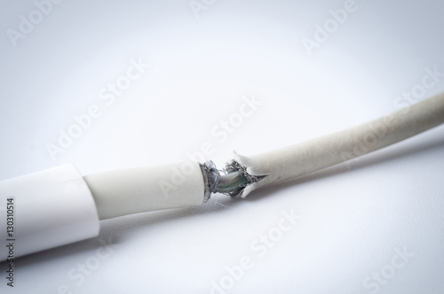 Fototapeta Naklejka Na Ścianę i Meble -  Closeup the Broken Smart Phone Charger Cable on white Background