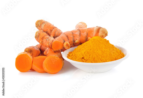 Turmeric roots with turmeric powder isolated on white background photo