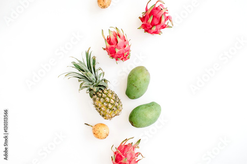 Exotic fruits: mango, pineapple, passion fruit and dragon fruit. Flat lay, top view