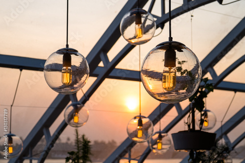 Beautiful vintage light bulbs hanging down under the outdoor sun roof.