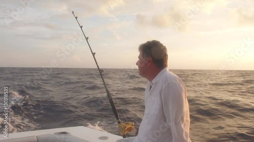 Mature Man In Boat Riding To Deep Sea Fishing