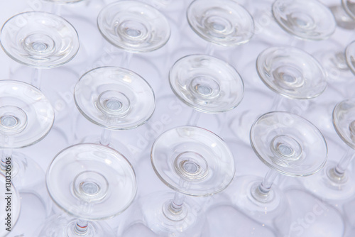 rows of Empty wine glass bottoms on white table