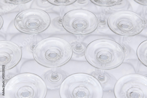 rows of Empty wine glass bottoms on white table