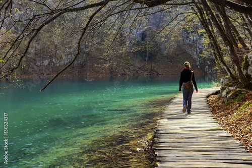 Visitor on wooden walkway path over Crystal Clear Waters of Plitvice Lakes National Park, Plitvice, Croatia photo