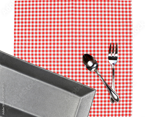 Top view plate with fork and spoon on tablecloth for food servin photo