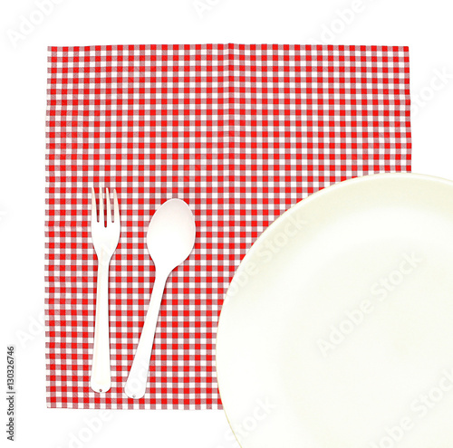 Top view plate with fork and spoon on tablecloth for food servin photo