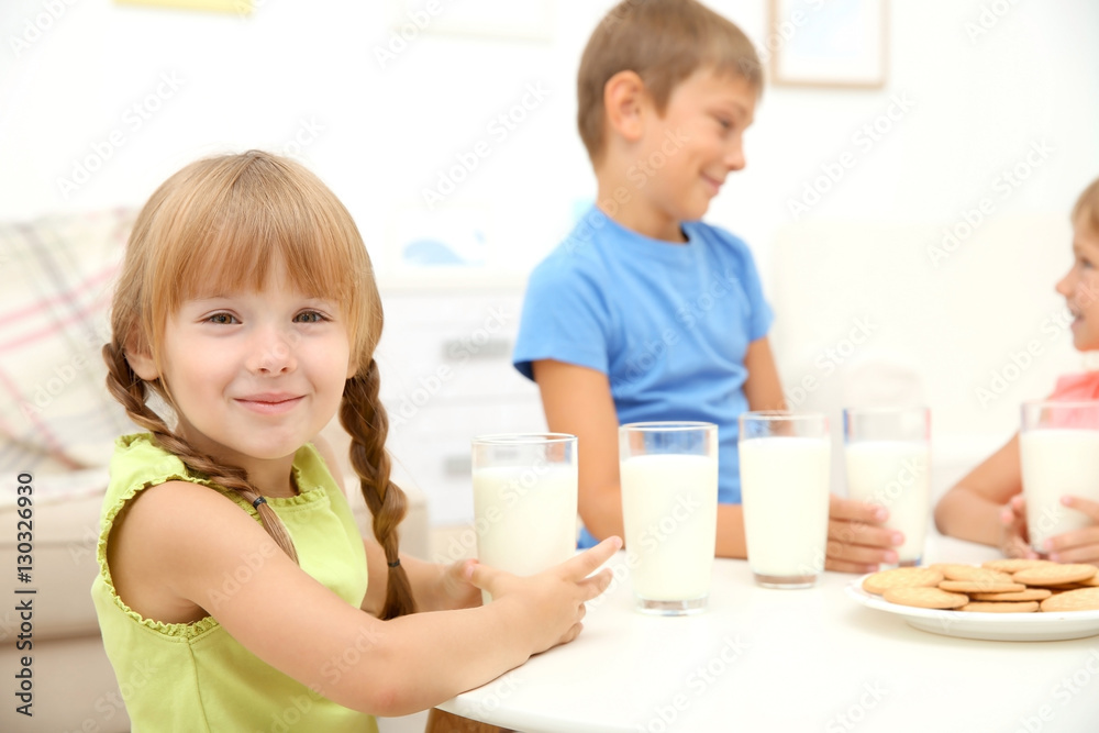 Portrait of little girl sitting at table with glass of milk Portrait of little girl sitting at table with glass of milk