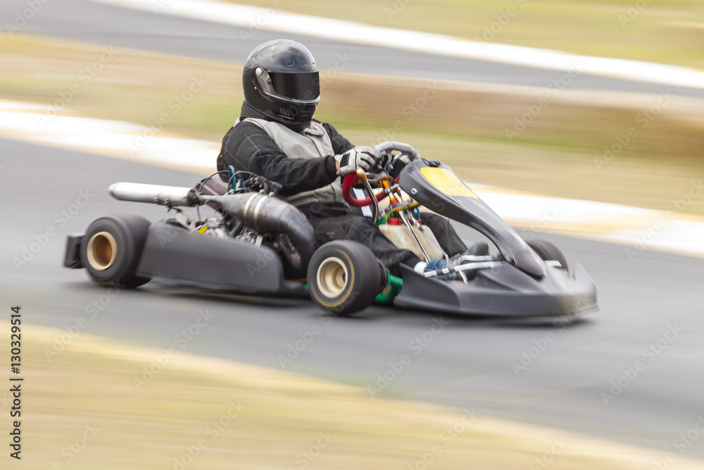 Fototapeta premium Go Kart Racer on Track, Panning Shot to show speed