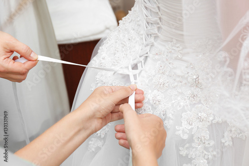Women lacing white wedding dress
