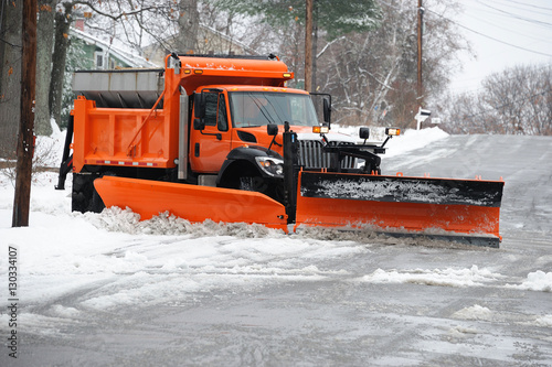 snowplow removing snow in the street after blizzard
