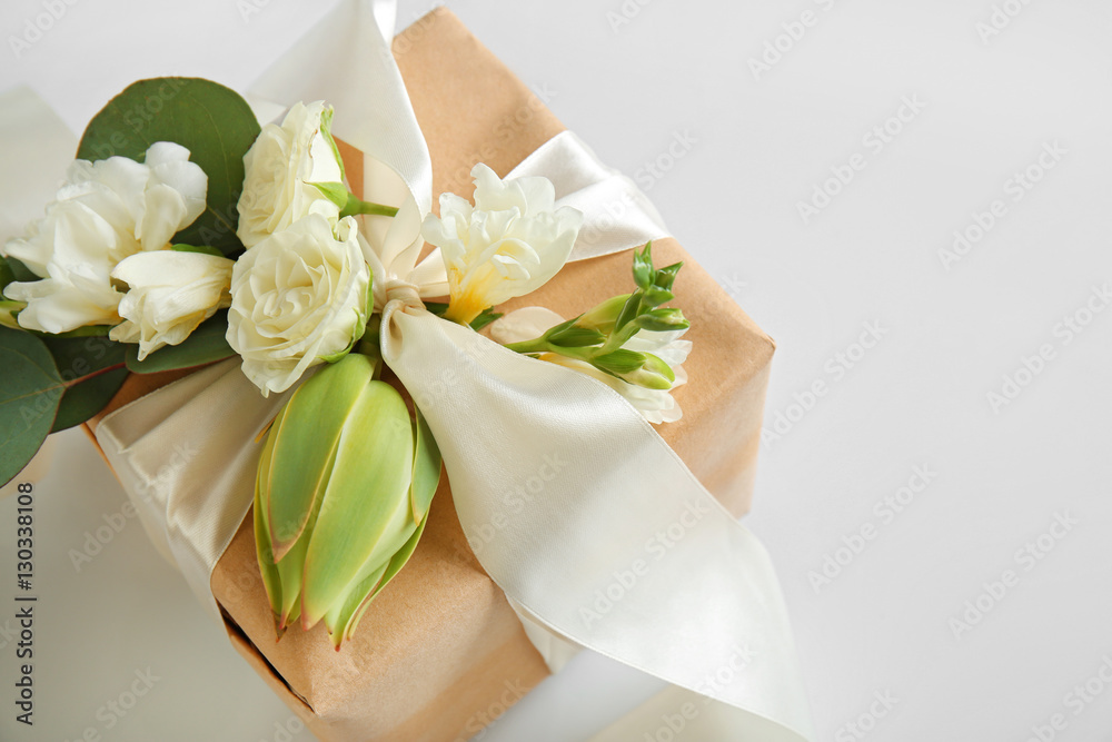 Fototapeta premium Handcrafted gift box with flowers on white background