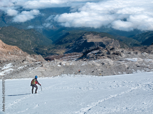 Hiker descending Mexico's highest mountain, Pico de Orizaba, that stands at  5,636 m (18,491 ft)