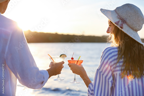 Man and woman holding glass...