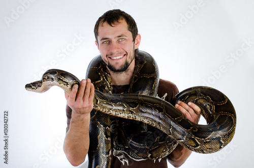 Beautiful man and snake in the studio