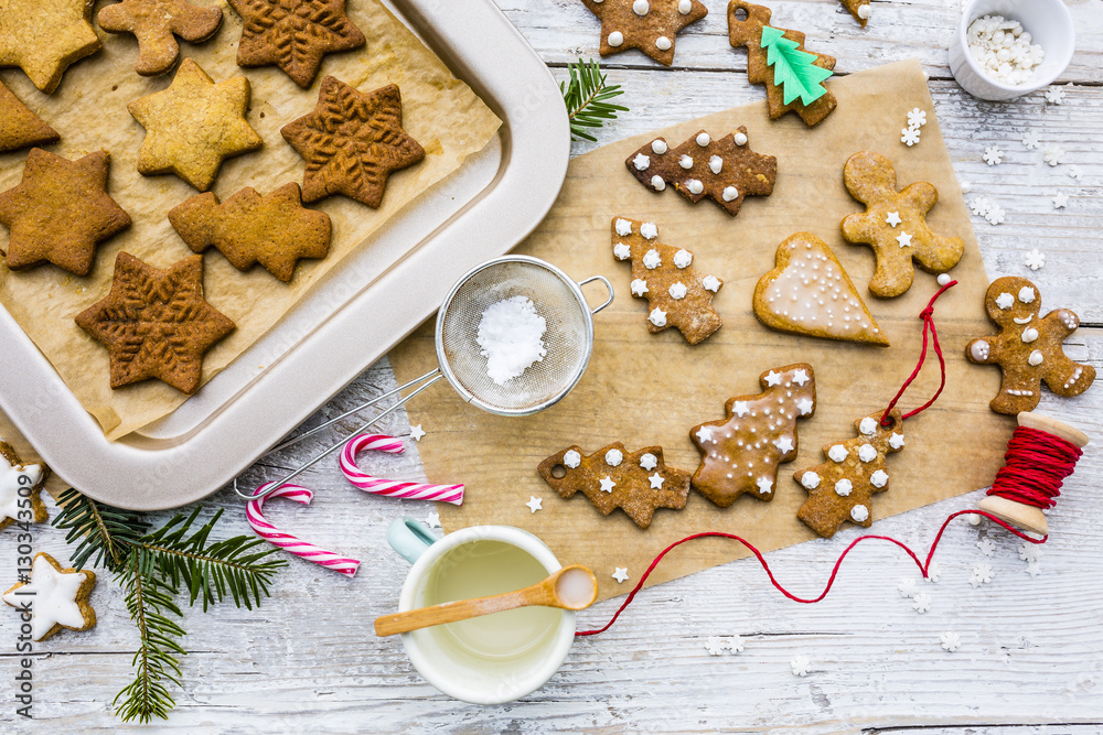 Top view of Christmas homemade gingerbreads and Christmas spices on a wooden background. Top view of Christmas homemade gingerbreads and Christmas spices on a wooden background.