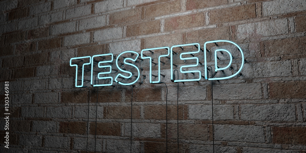 Naklejka premium TESTED - Glowing Neon Sign on stonework wall - 3D rendered royalty free stock illustration. Can be used for online banner ads and direct mailers..