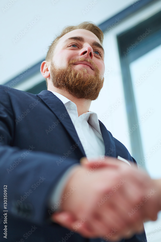 Male and female handshake in office. Serious business and partnership concept. Male and female handshake in office. Serious business and partnership concept.