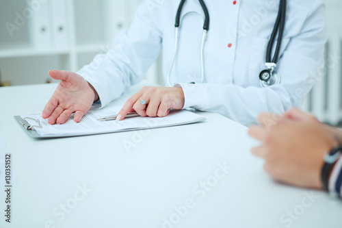 Doctor talking to her female patient at office. Healthcare and medical concept.