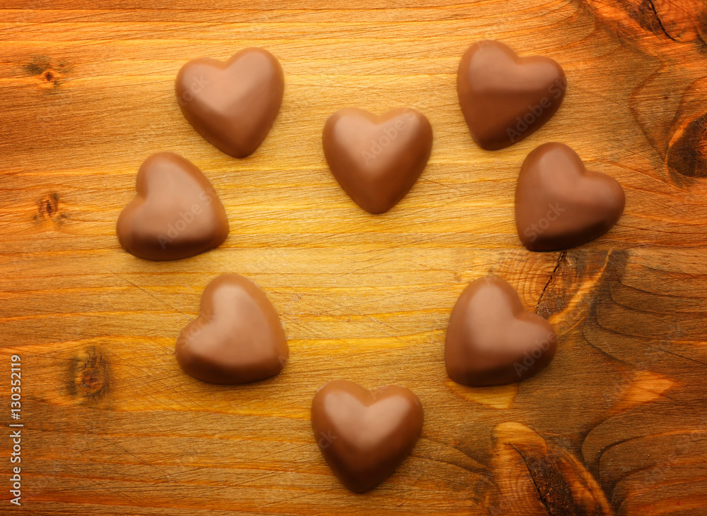 Obraz premium Chocolate hearts on wooden background