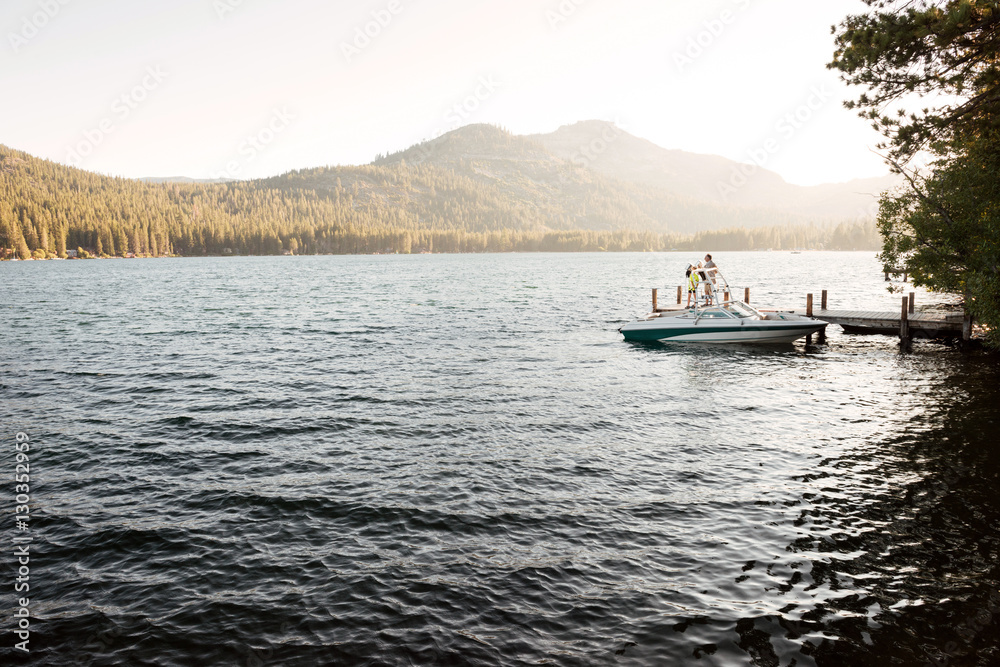 Man standing on a boat and watching sunrise Man standing on a boat and watching sunrise