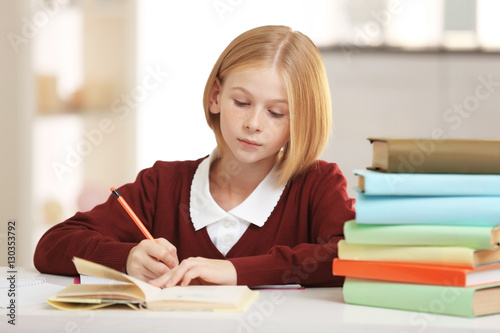 Schoolgirl doing lessons at...