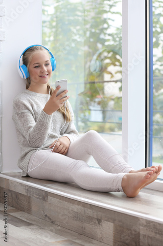 Cute teenager with headphon...