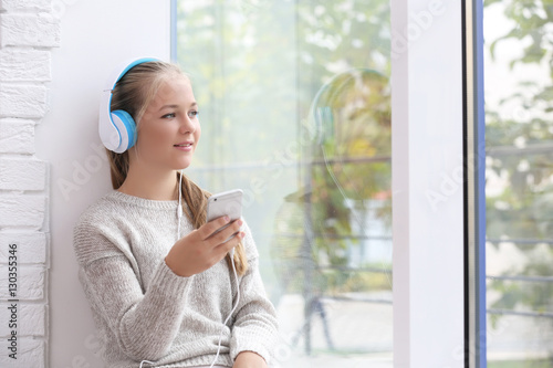Cute teenager with headphon...